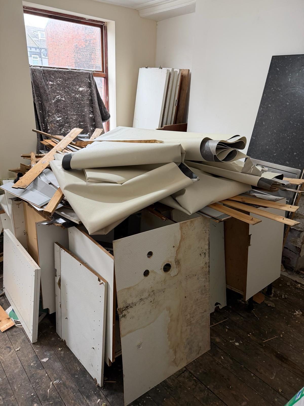Room with dismantled fixtures and materials ready for a property clearance